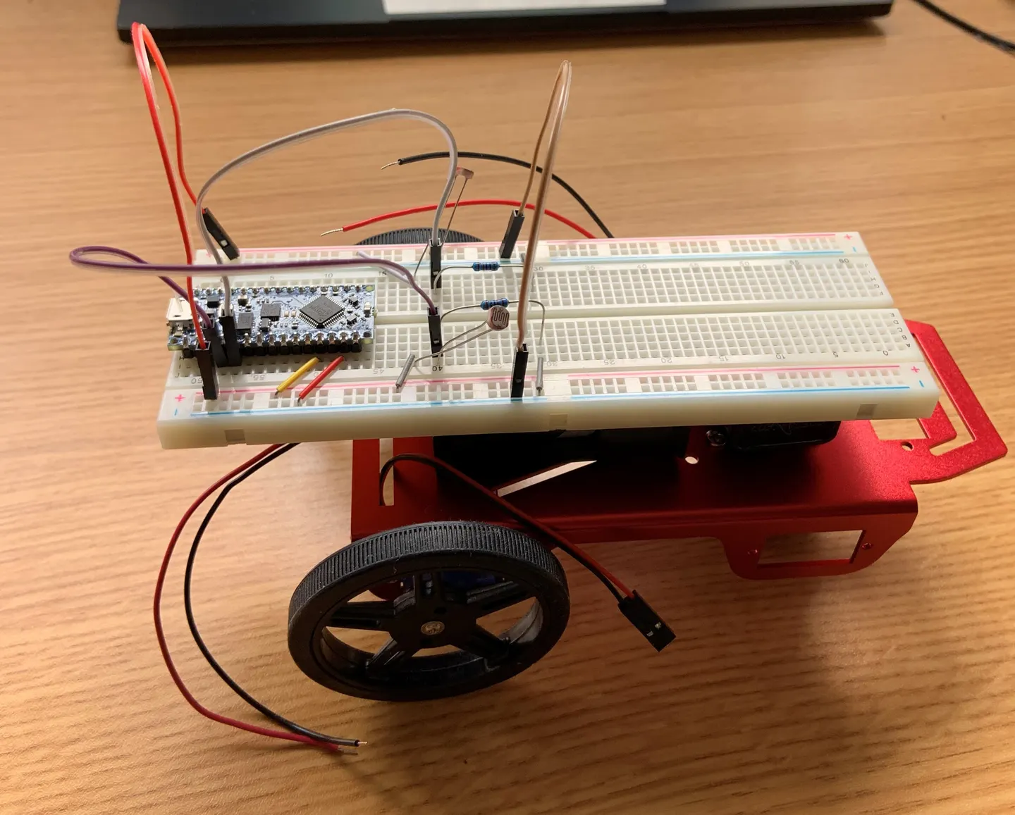 Side view of the light-sensing robot and its breadboard wiring.